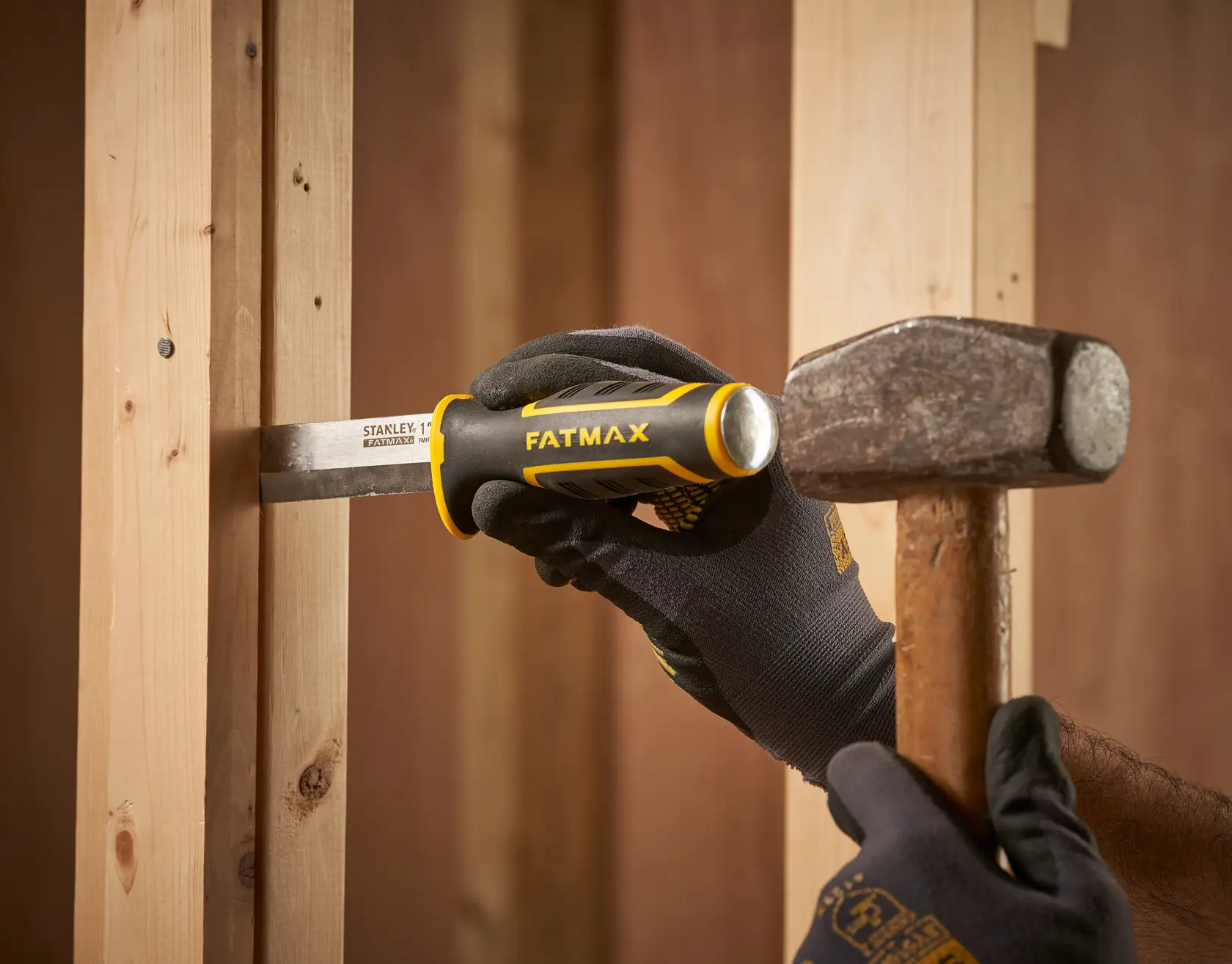 Stanley FMHT16693-0 cincel con mango FATMAX usado en marco de madera, golpeado con martillo.