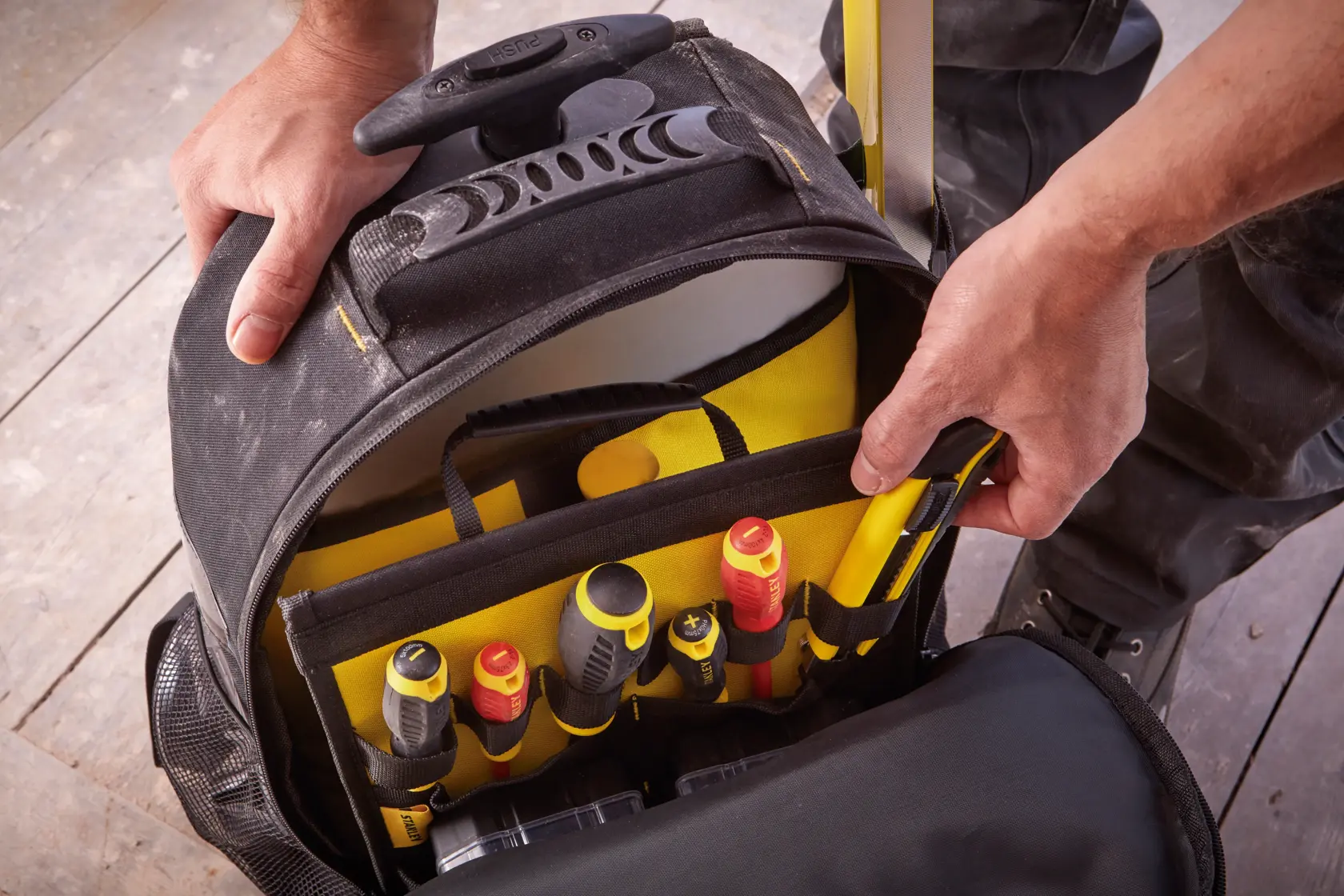 Bolsa de ferramentas STANLEY STST83307-1 com vários compartimentos e ferramentas manuais, vista superior.